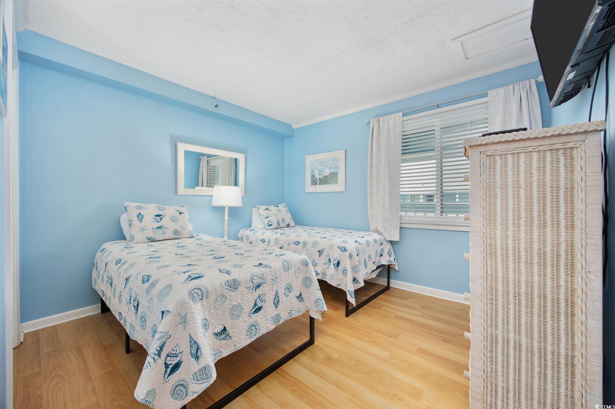 720 North Waccamaw Drive, Unit 301 Murrells Inlet, SC 29576 - Photo 14 of 37 Bedroom with wood finished floors, attic access, a textured ceiling, and crown molding