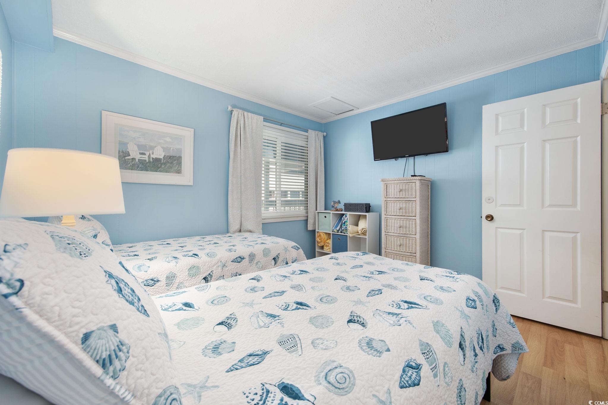 720 North Waccamaw Drive, Unit 301 Murrells Inlet, SC 29576 - Photo 15 of 37 Bedroom with ornamental molding and wood finished floors