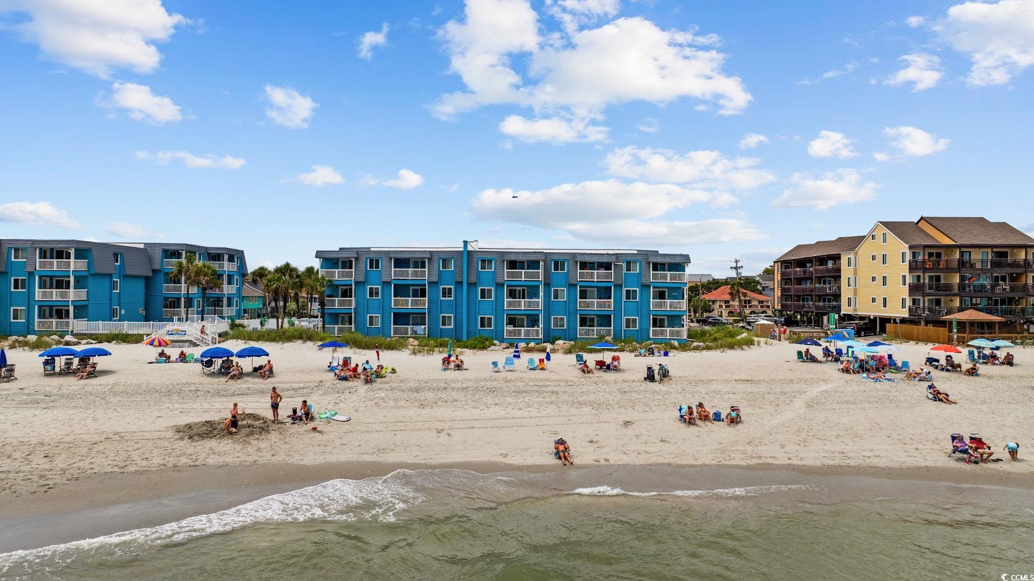 720 North Waccamaw Drive, Unit 301 Murrells Inlet, SC 29576 - Photo 28 of 37 View of building exterior with view of local beach