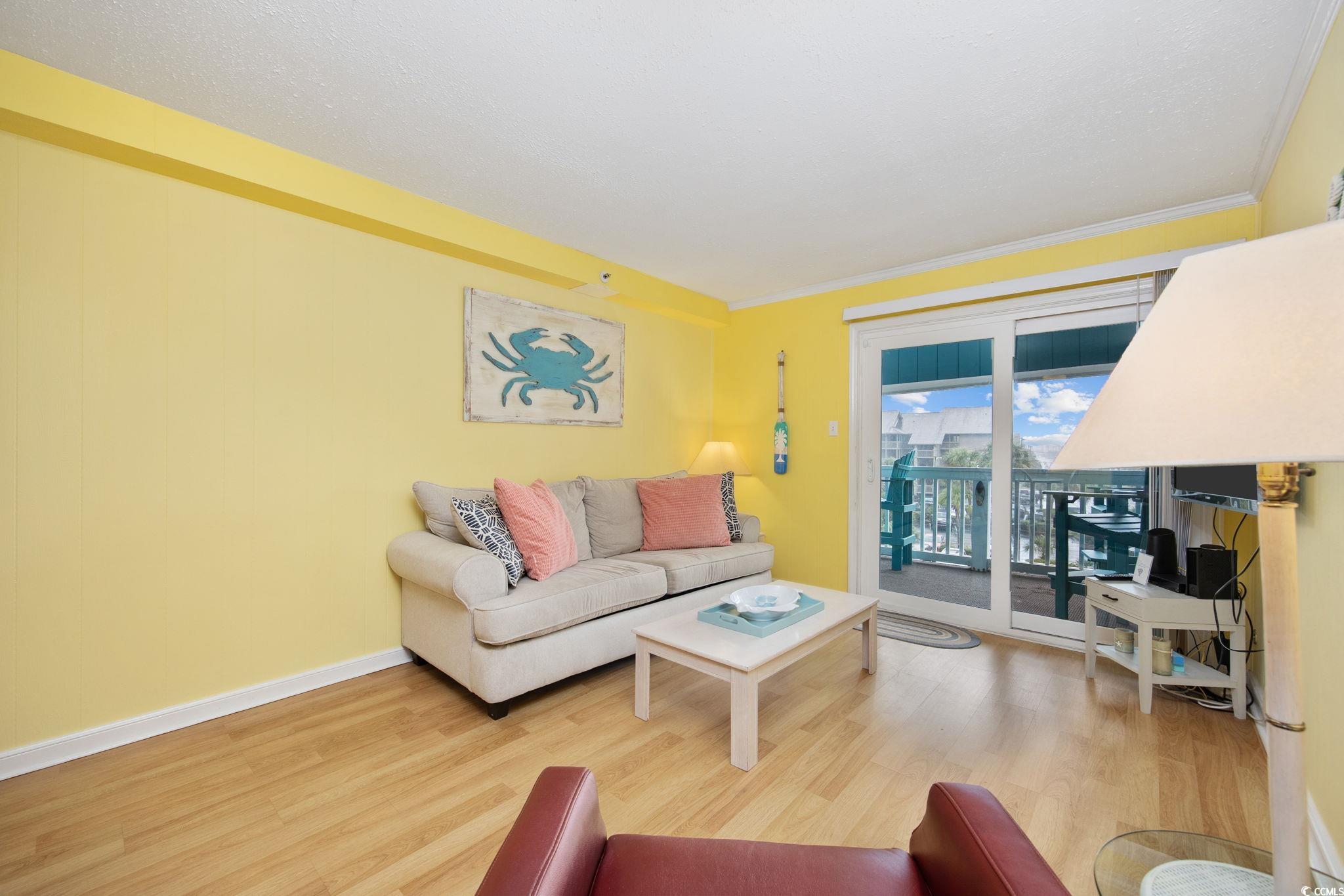 720 North Waccamaw Drive, Unit 301 Murrells Inlet, SC 29576 - Photo 8 of 37 Living room featuring wood finished floors and crown molding