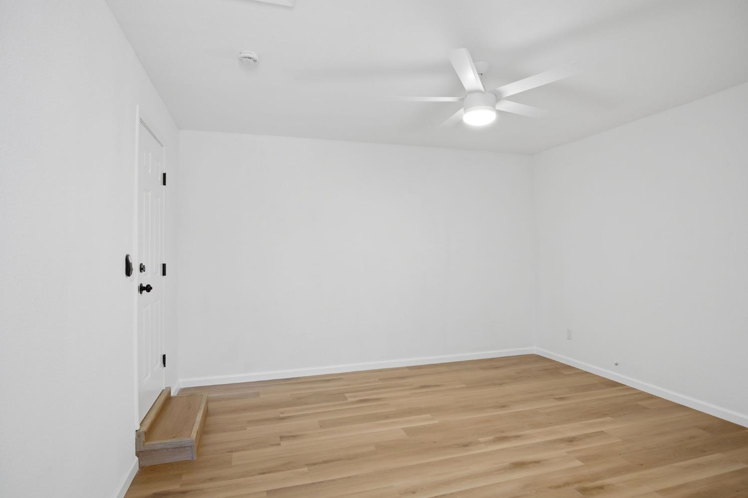1451 Kent Way Modesto, CA 95355 - Photo 28 of 37 a view of an empty room with wooden floor