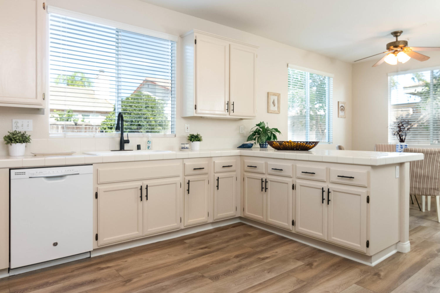 1423 Lorena Drive Oxnard, CA 93030 - Photo 11 of 30 a kitchen with white cabinets window and sink