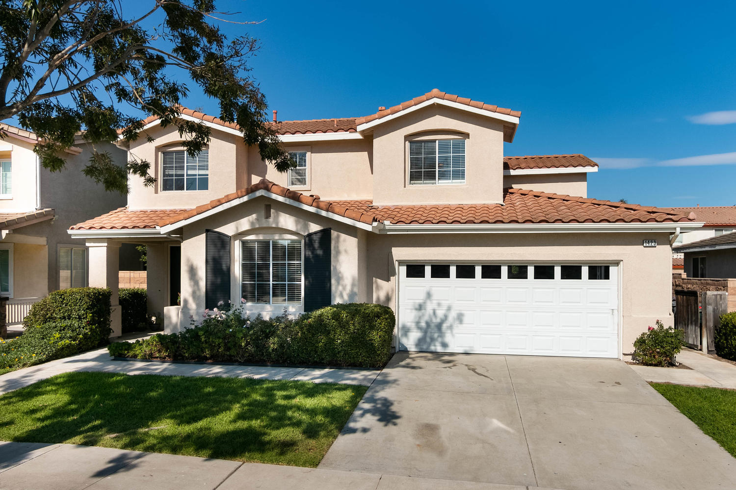 1423 Lorena Drive Oxnard, CA 93030 - Photo 2 of 30 a front view of a house with a yard and garage