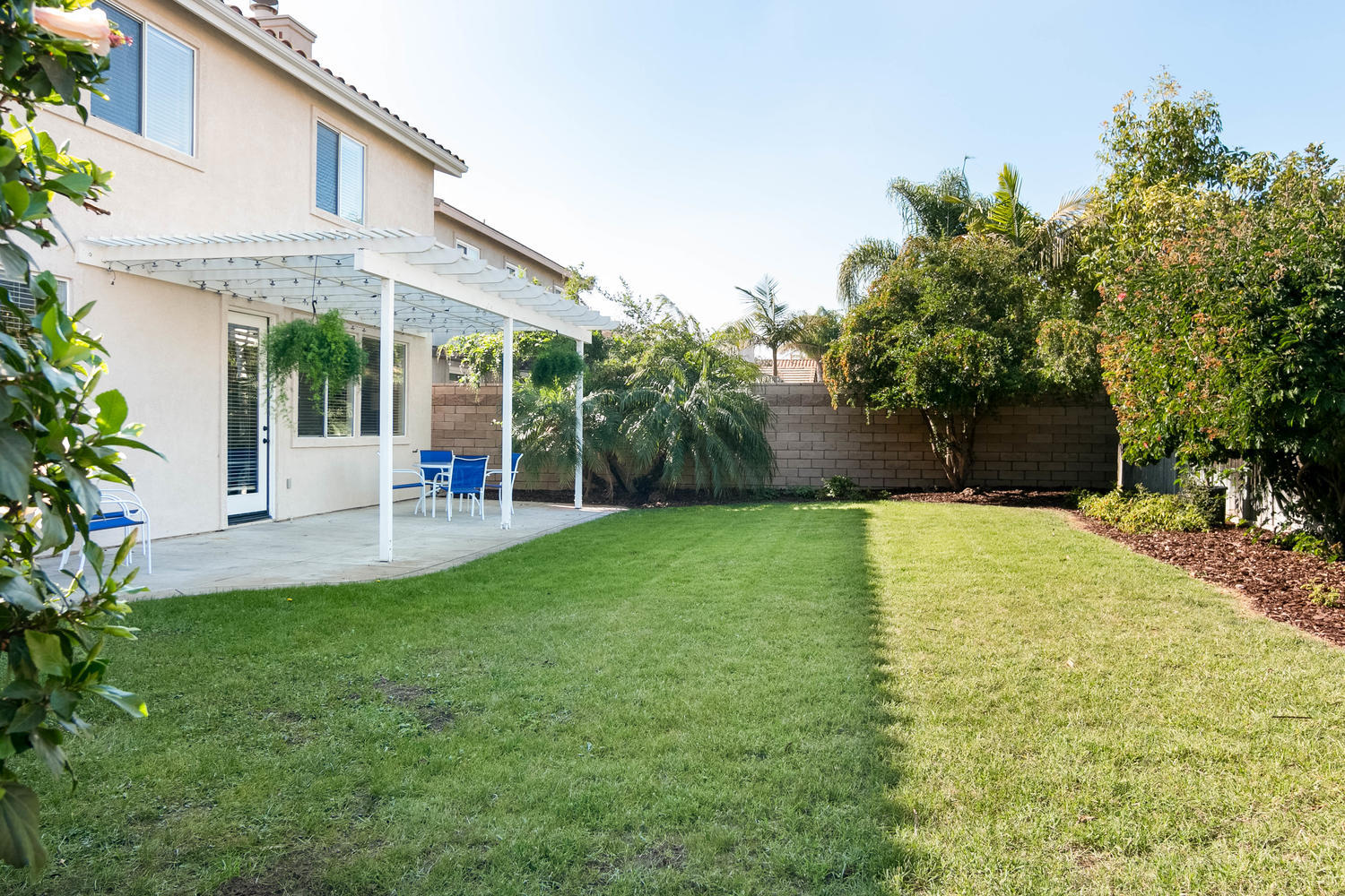 1423 Lorena Drive Oxnard, CA 93030 - Photo 29 of 30 a view of a patio with table and chairs potted plants and large tree