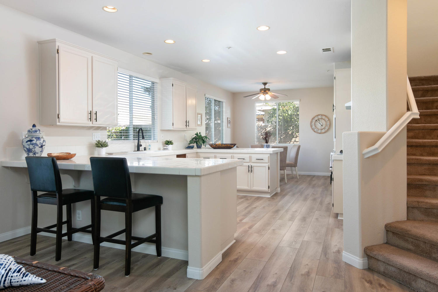 1423 Lorena Drive Oxnard, CA 93030 - Photo 10 of 30 a kitchen with a sink chairs and white cabinets