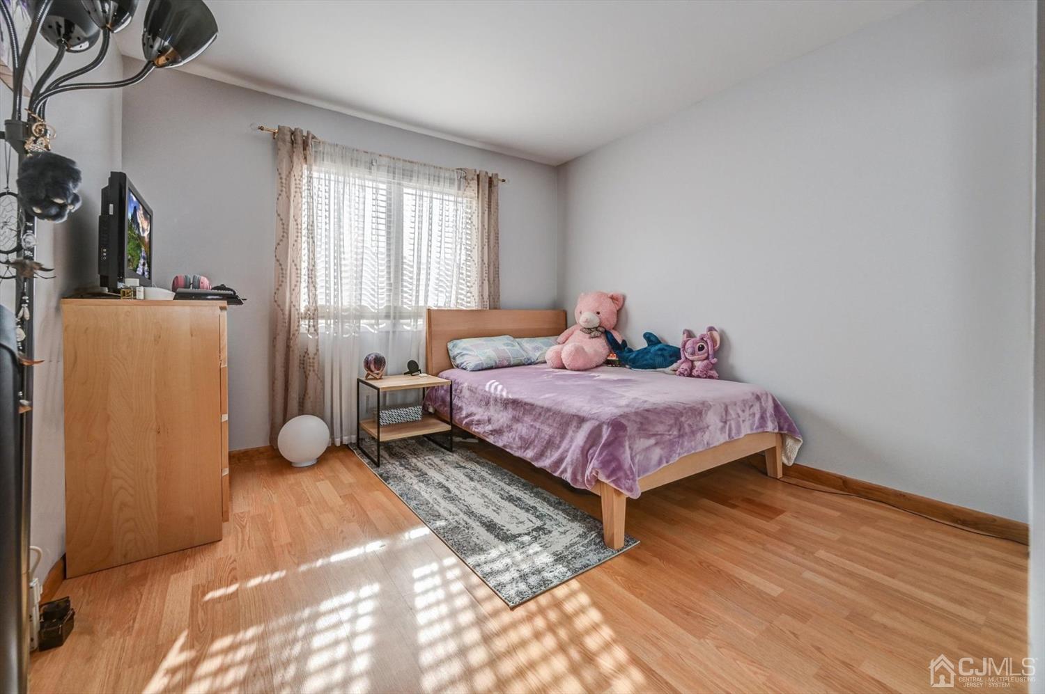 136 Redpine Loop Old Bridge, NJ 08857 - Photo 23 of 31 a bedroom with a bed and wooden floor
