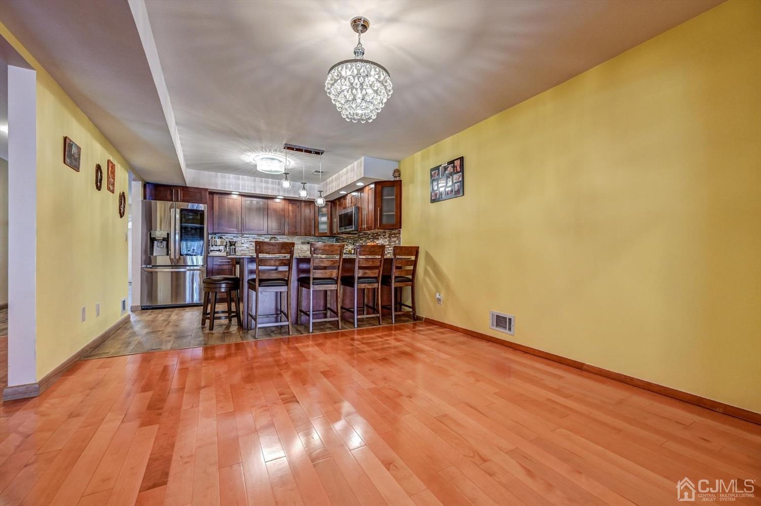 136 Redpine Loop Old Bridge, NJ 08857 - Photo 10 of 31 a view of a room with chairs and chandelier