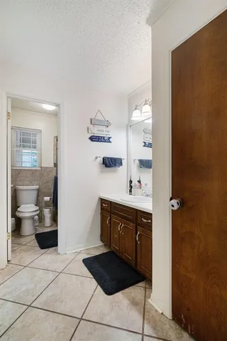 a spacious bathroom with a sink a toilet and shower