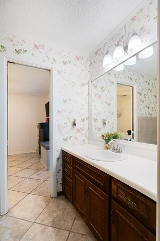 a spacious bathroom with a sink double vanity and a mirror