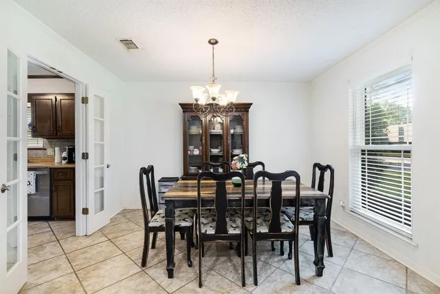 a view of a dining room with furniture and window