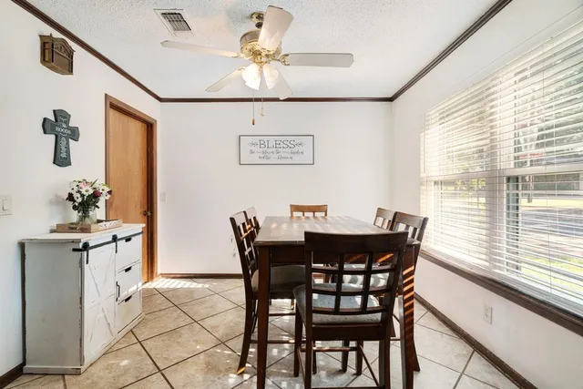 a view of a dining room that has a table and chairs