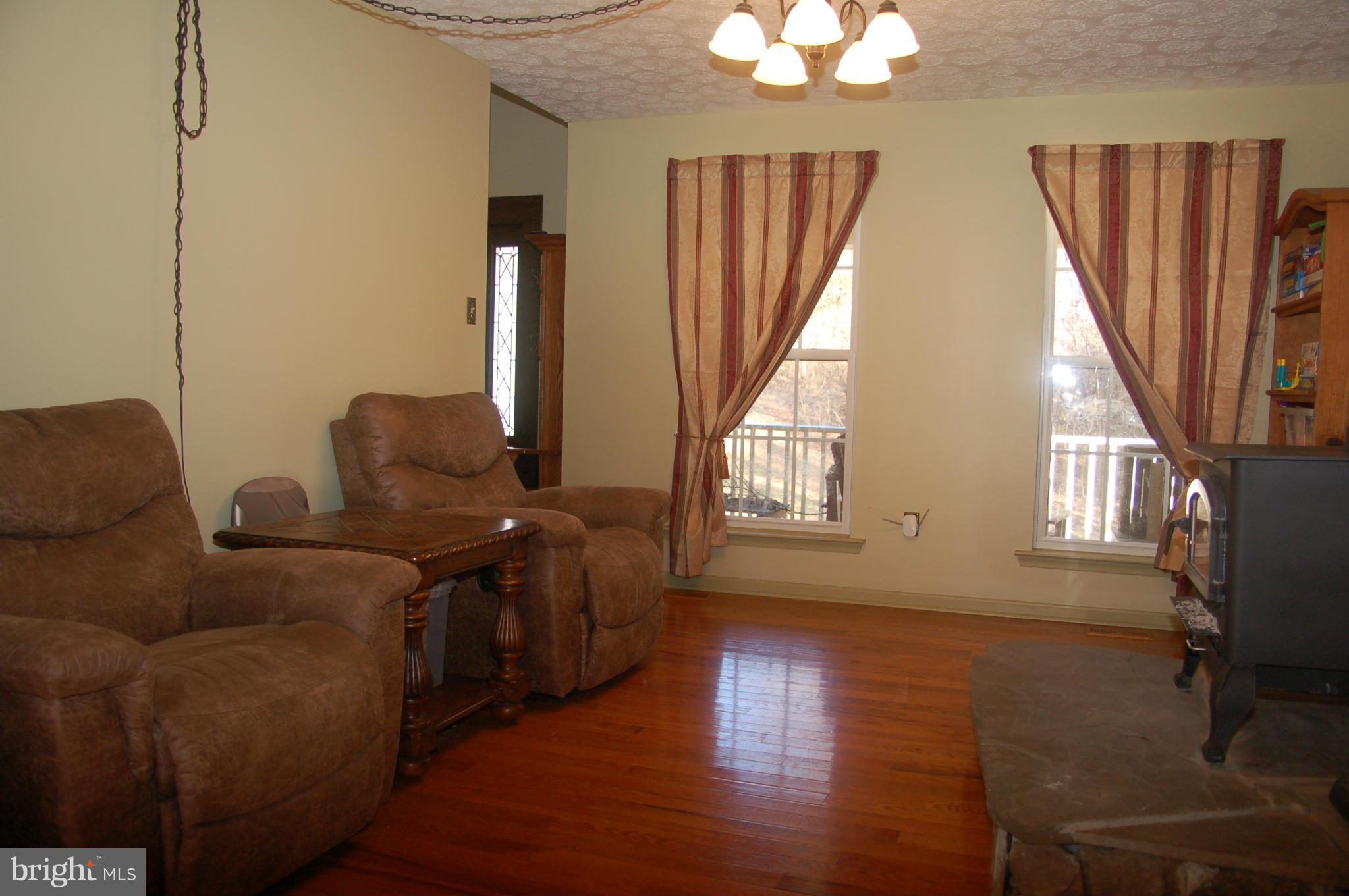 78 Beaver Court Rising Sun, MD 21911 - Photo 8 of 30 a living room with furniture a fireplace and a large window