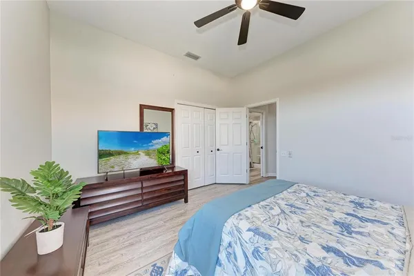 a bedroom with a bed and a potted plant