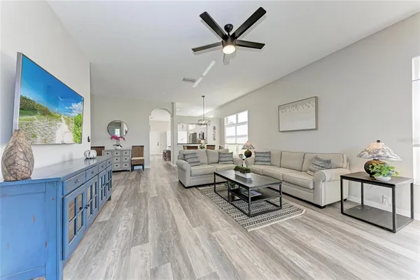 a living room with furniture and a wooden floor