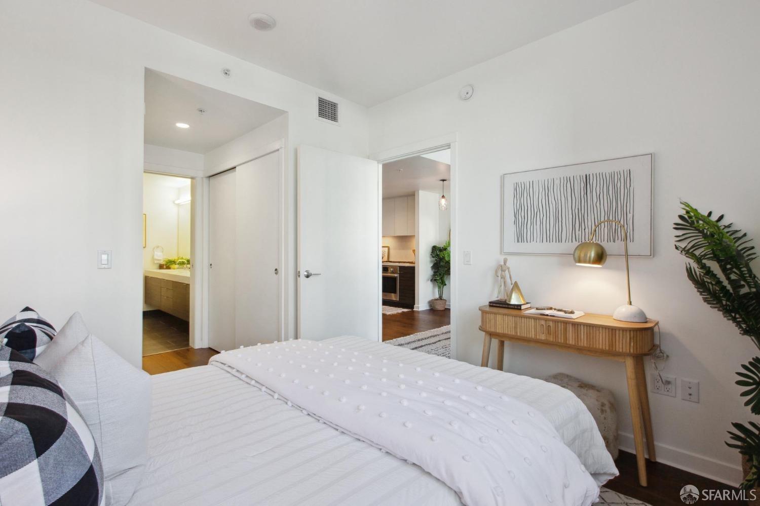 1688 Pine Street, Unit E601 San Francisco, CA 94109 - Photo 14 of 51 a bedroom with a bed and a potted plant