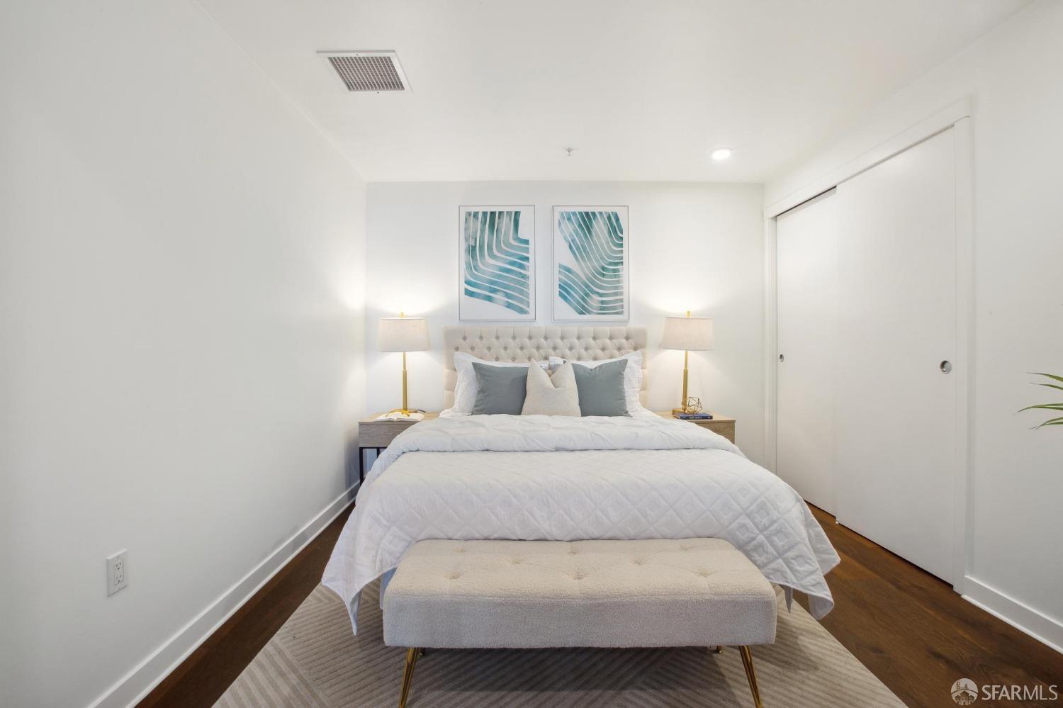 1688 Pine Street, Unit E601 San Francisco, CA 94109 - Photo 19 of 51 a bedroom with a bed and night stand