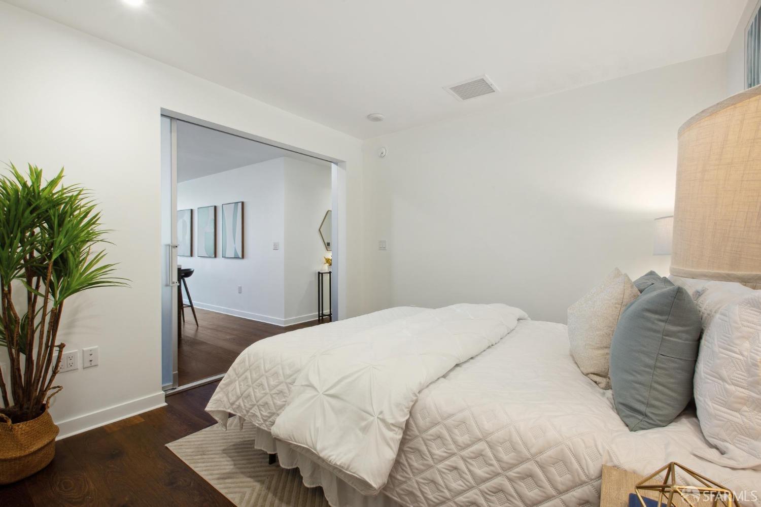 1688 Pine Street, Unit E601 San Francisco, CA 94109 - Photo 20 of 51 a bedroom with a bed and a potted plant