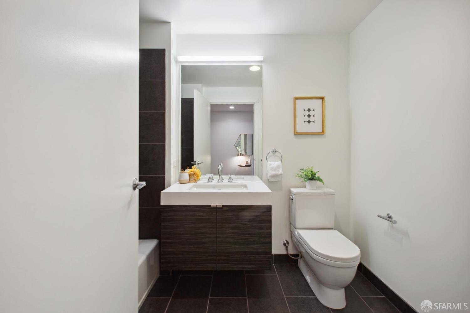 1688 Pine Street, Unit E601 San Francisco, CA 94109 - Photo 22 of 51 a bathroom with a sink toilet and mirror