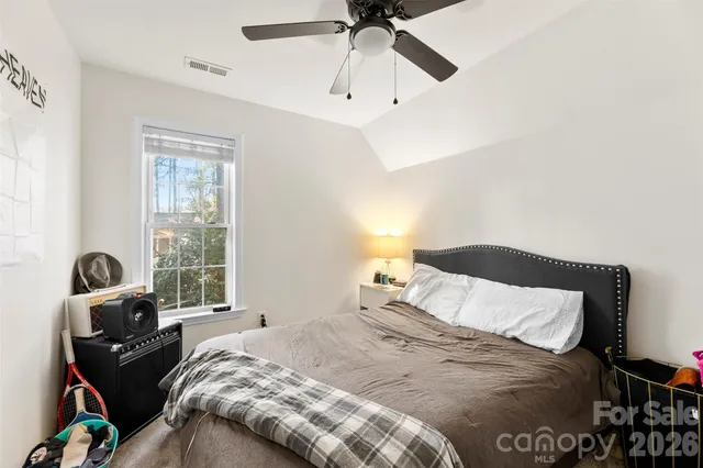 a bedroom with a bed and window