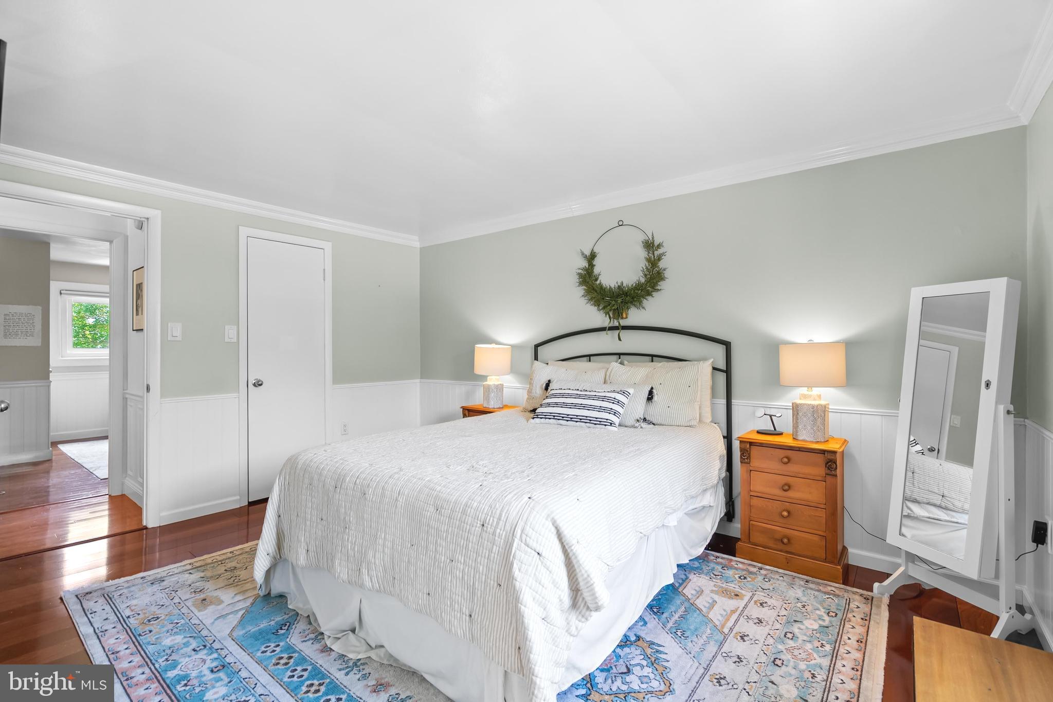 7029 Leewood Forest Drive Springfield, VA 22151 - Photo 21 of 45 a bedroom with a bed and wooden floor