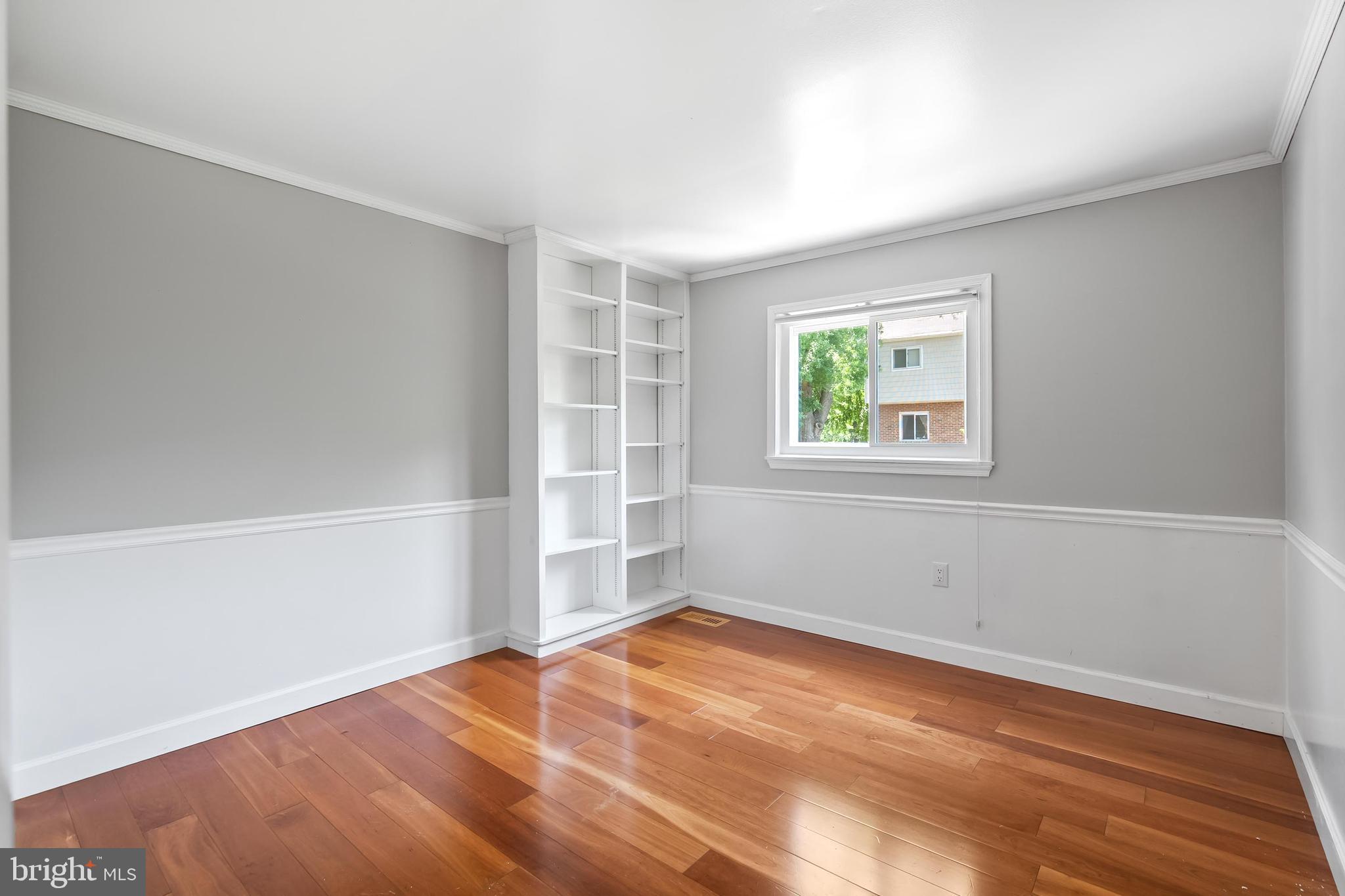 7029 Leewood Forest Drive Springfield, VA 22151 - Photo 28 of 45 an empty room with wooden floor and windows
