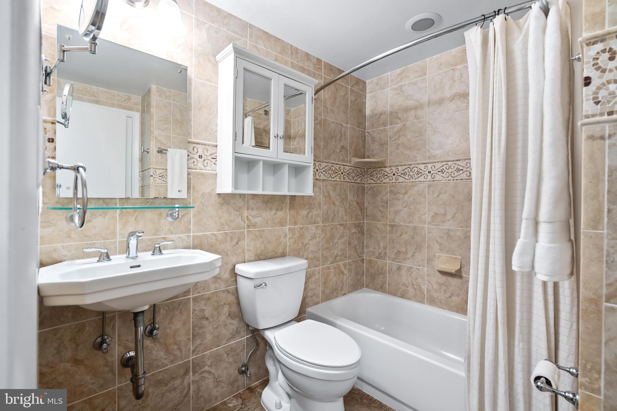 7029 Leewood Forest Drive Springfield, VA 22151 - Photo 29 of 45 a bathroom with a sink toilet and shower