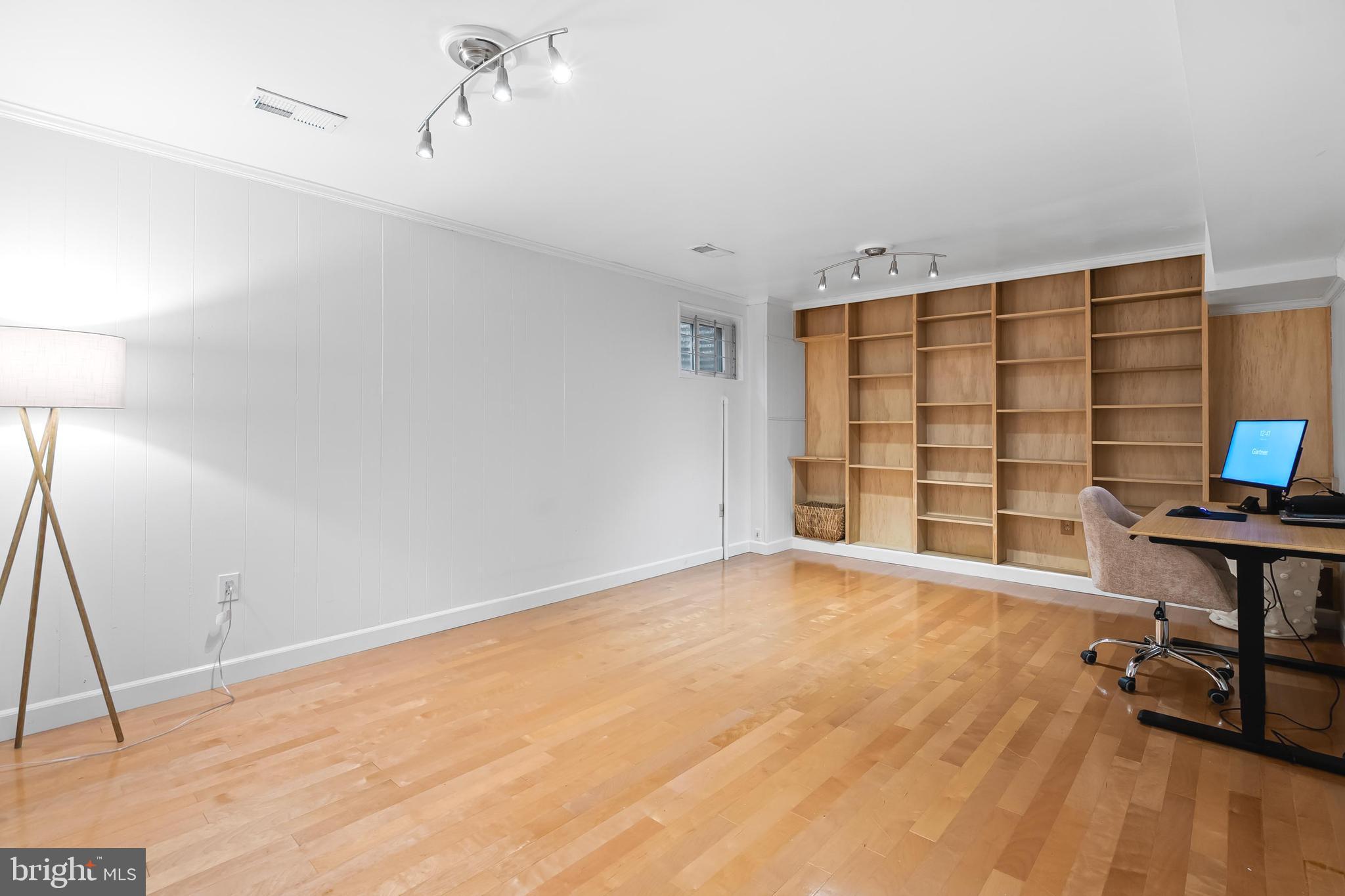 7029 Leewood Forest Drive Springfield, VA 22151 - Photo 31 of 45 a view of an empty room with furniture and wooden floor