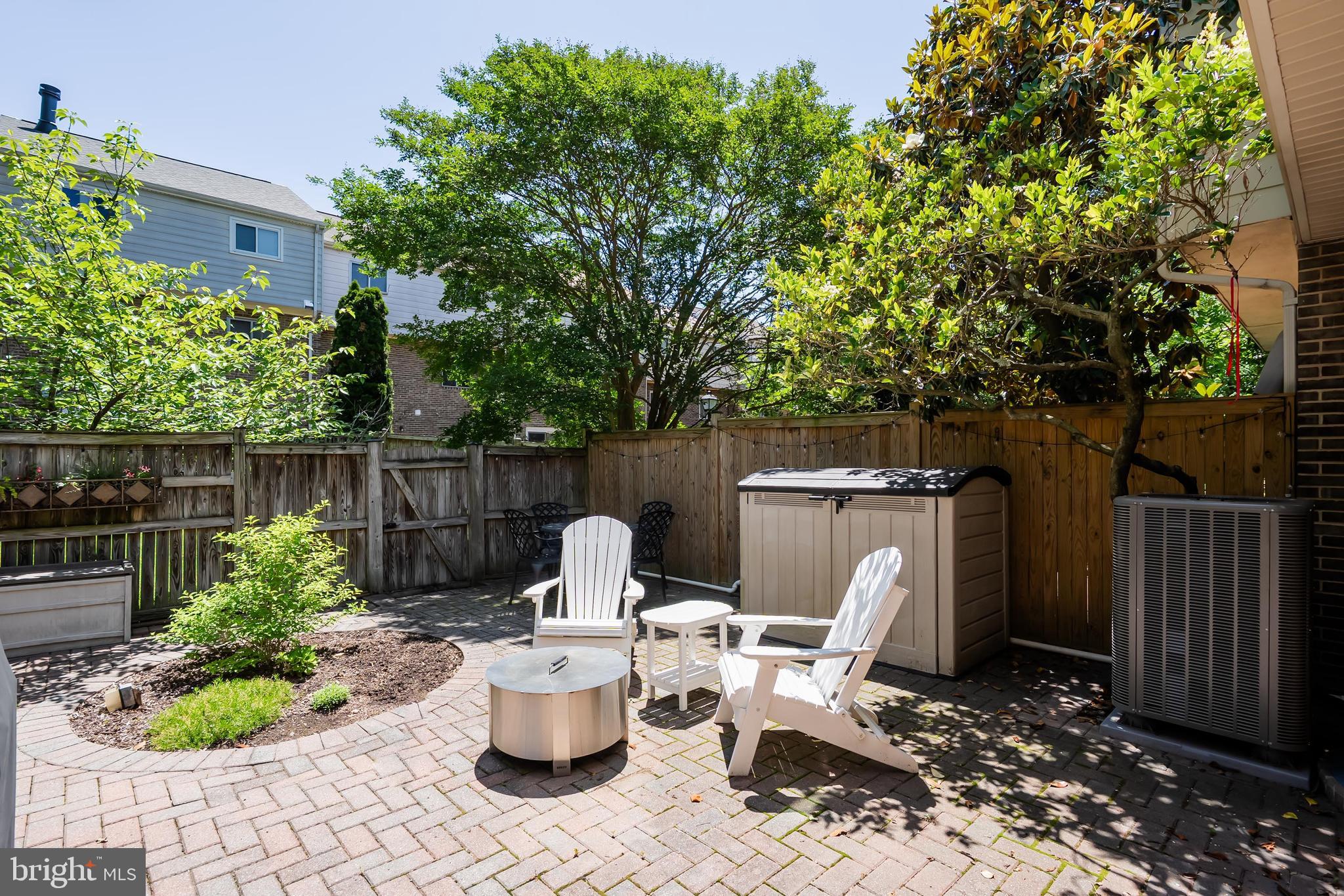 7029 Leewood Forest Drive Springfield, VA 22151 - Photo 37 of 45 a view of a patio with table and chairs potted plants and tree