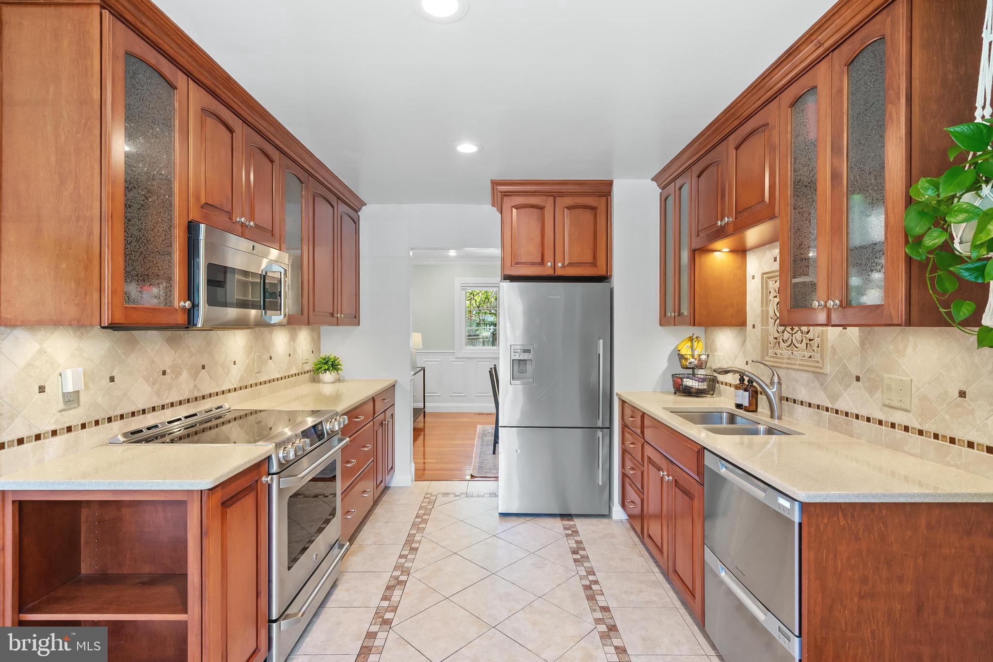 7029 Leewood Forest Drive Springfield, VA 22151 - Photo 4 of 45 a kitchen with a sink stove and refrigerator