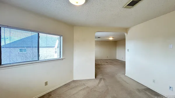 an empty room with windows and entrance