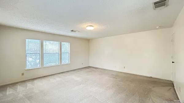 an empty room with a empty space and windows