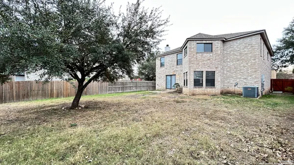 a white house that has a tree in front of it