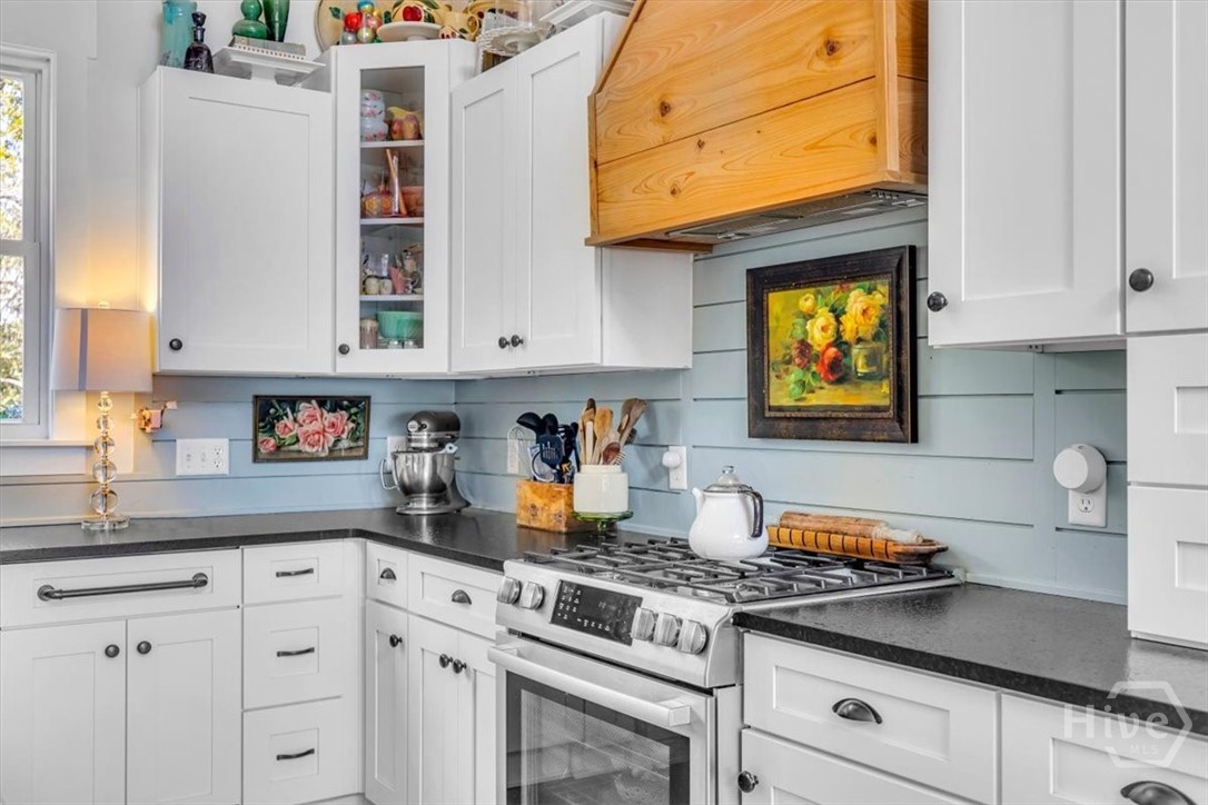 690 Japonica Road Midway, GA 31320 - Photo 11 of 70 Custom cypress wood vent hood to match the beams in the living room.