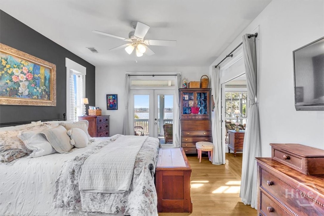 690 Japonica Road Midway, GA 31320 - Photo 19 of 70 Primary suite with attached bath and doors that open onto the screen porch.