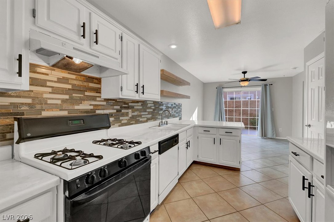 10148 Tree Bark Street Las Vegas, NV 89183 - Photo 15 of 37 A well-equipped kitchen features a gas range and sleek white cabinetry, perfect for culinary endeavors.