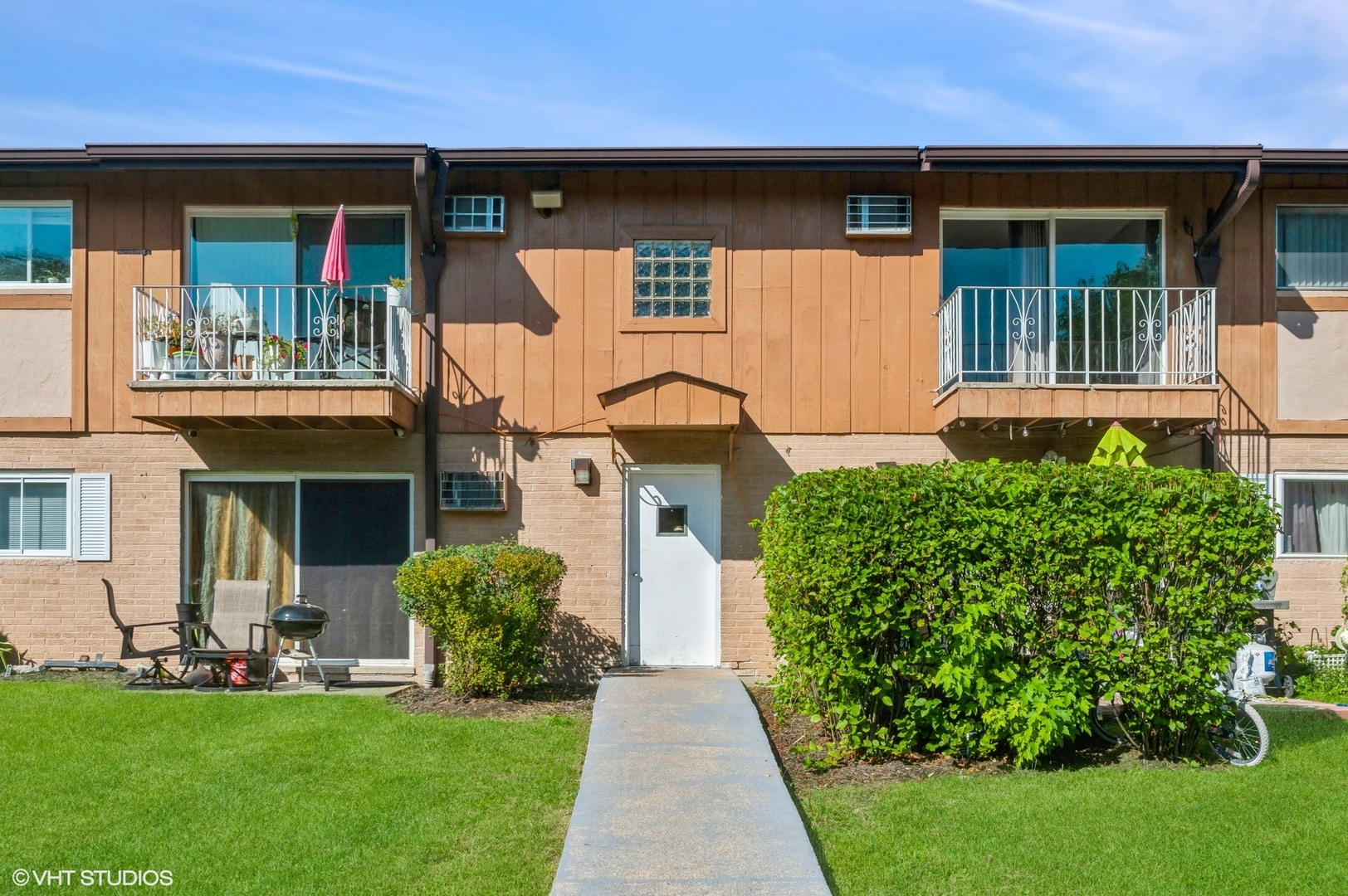 a front view of a house with a garden and plants