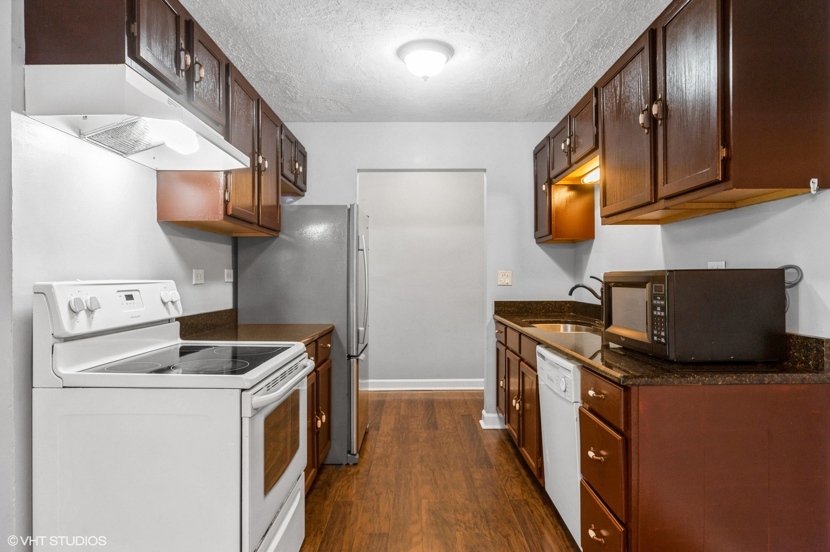 880 East Old Willow Road, Unit 175 Prospect Heights, IL 60070 - Photo 7 of 12 a kitchen with stainless steel appliances granite countertop a stove a sink and a refrigerator