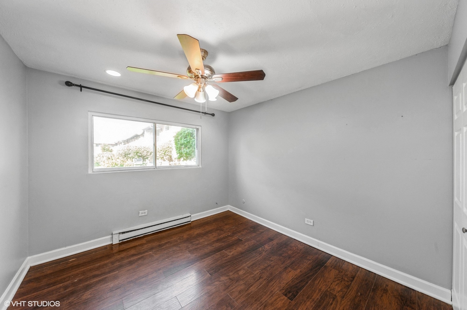 880 East Old Willow Road, Unit 175 Prospect Heights, IL 60070 - Photo 10 of 12 an empty room with wooden floor ceiling fan and window