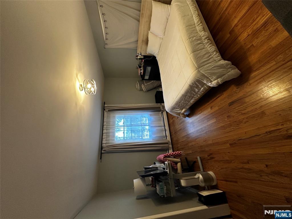 4 Rea Ave Extension, Unit 1 Hawthorne, NJ 07506 - Photo 11 of 18 a bedroom with a bed and wooden floor
