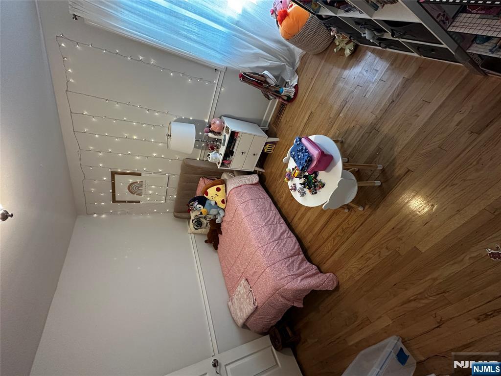 4 Rea Ave Extension, Unit 1 Hawthorne, NJ 07506 - Photo 16 of 18 a bedroom with furniture and a wooden floor