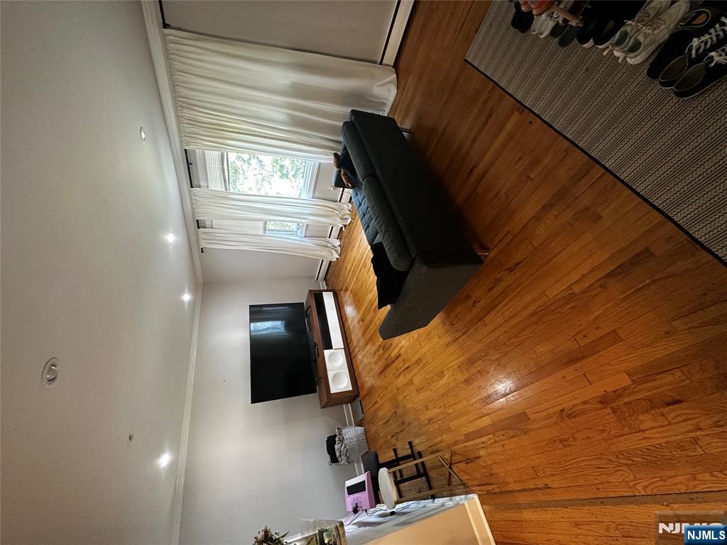 4 Rea Ave Extension, Unit 1 Hawthorne, NJ 07506 - Photo 4 of 18 a bedroom with a bed and a flat screen tv