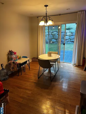 a view of a room with furniture wooden floor and chandelier