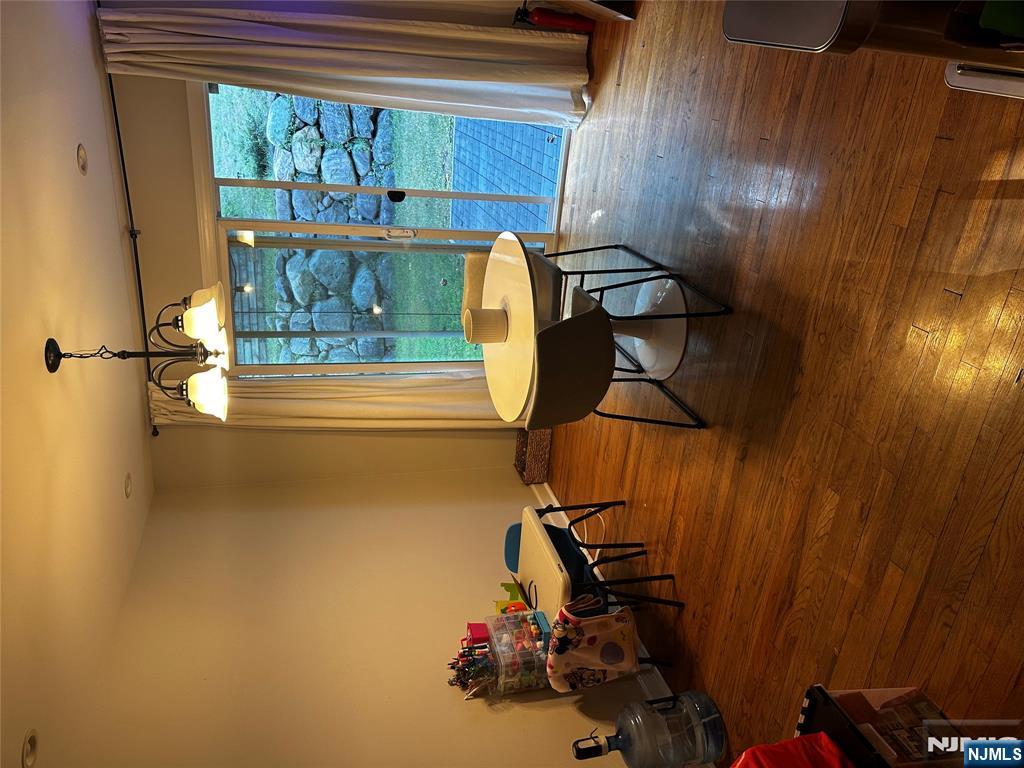 4 Rea Ave Extension, Unit 1 Hawthorne, NJ 07506 - Photo 6 of 18 a view of a room with furniture wooden floor and chandelier