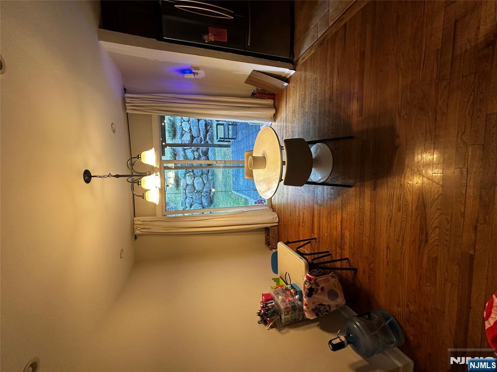 4 Rea Ave Extension, Unit 1 Hawthorne, NJ 07506 - Photo 7 of 18 a living room with furniture a rug and a chandelier