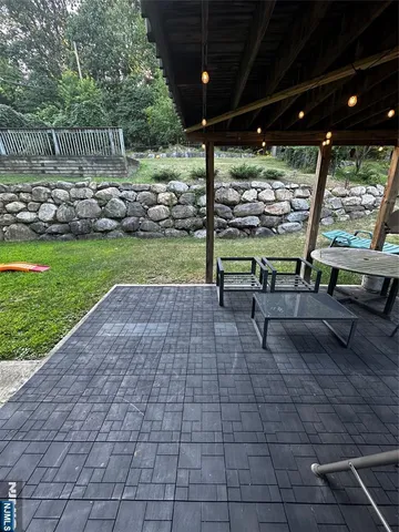a view of a porch with furniture and garden
