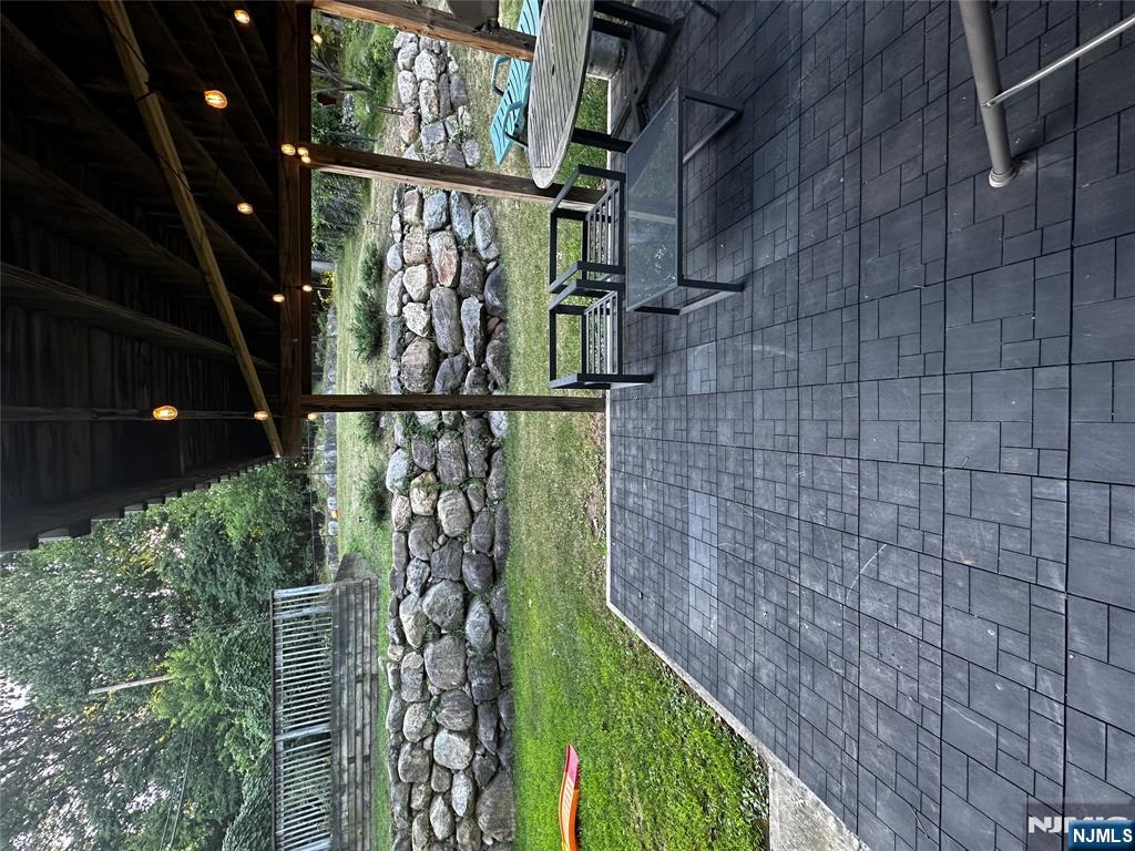 4 Rea Ave Extension, Unit 1 Hawthorne, NJ 07506 - Photo 8 of 18 a view of a porch with furniture and garden