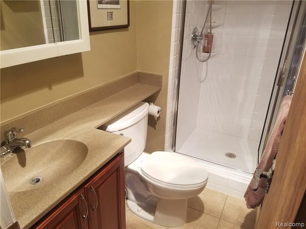 36214 Smithfield Road Farmington, MI 48335 - Photo 14 of 41 Full bath in lower level with solid surface countertop and ceramic shower and floor
