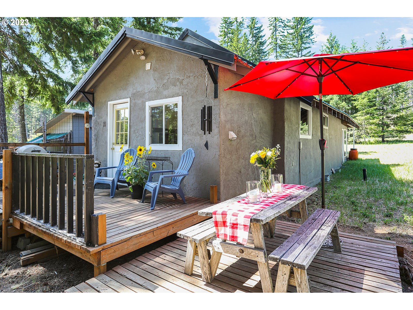 21 Prairie Road Appleton, WA 98602 - Photo 2 of 39 a view of a patio with a table and chairs under an umbrella