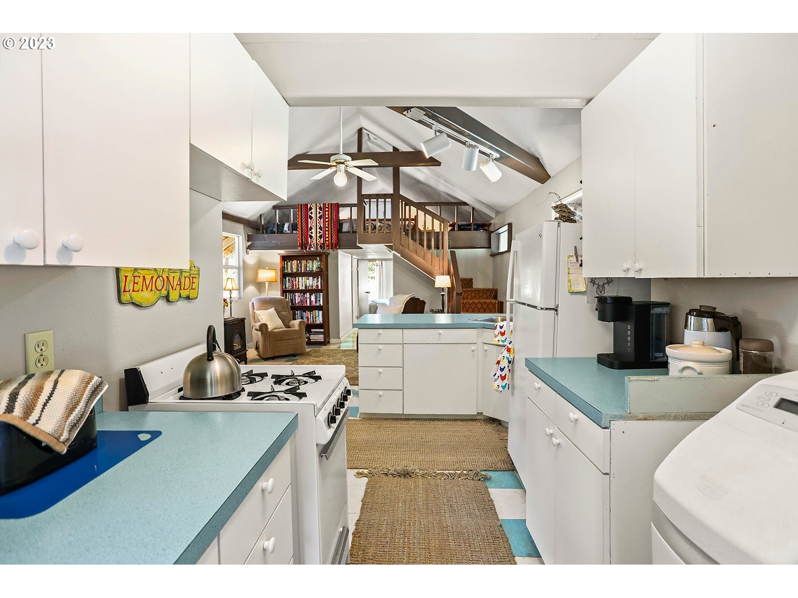 21 Prairie Road Appleton, WA 98602 - Photo 24 of 39 a kitchen with stainless steel appliances kitchen island granite countertop a sink stove and white cabinets