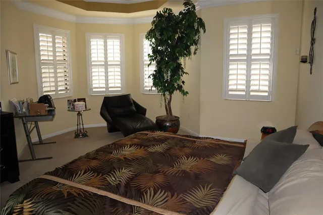 a bed room with a bed and a chair